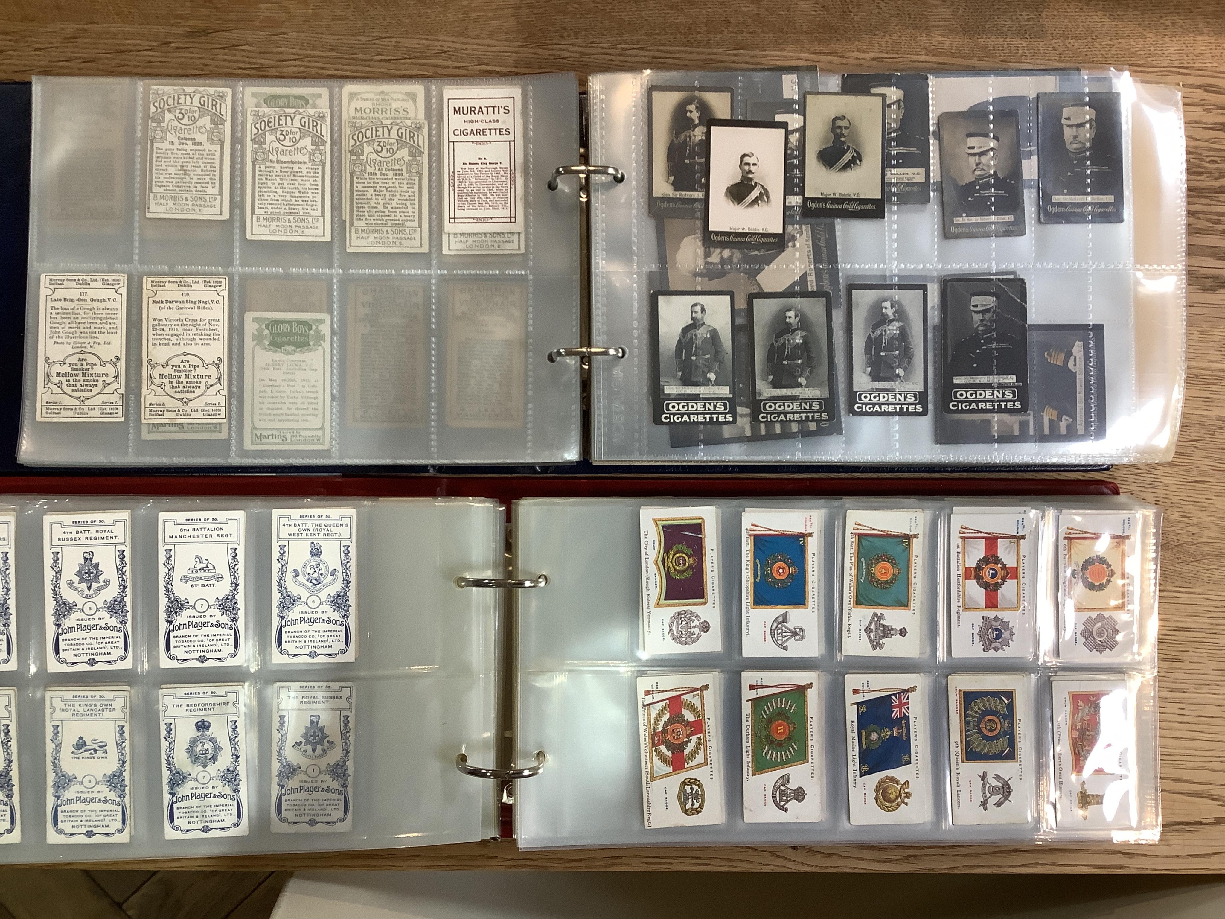 Four albums of assorted cigarette cards; military badges, heroes, soldiers and war, and some loose silks.